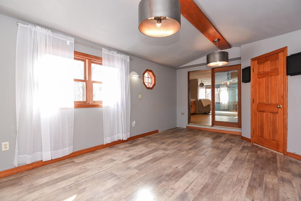 73 Drew Road Derry, NH 03038 - Photo 14 of 42 a view of an empty room with window and wooden floor