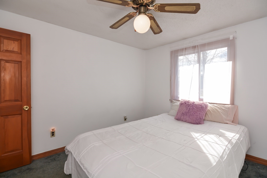 73 Drew Road Derry, NH 03038 - Photo 18 of 42 a bedroom with a bed and a window