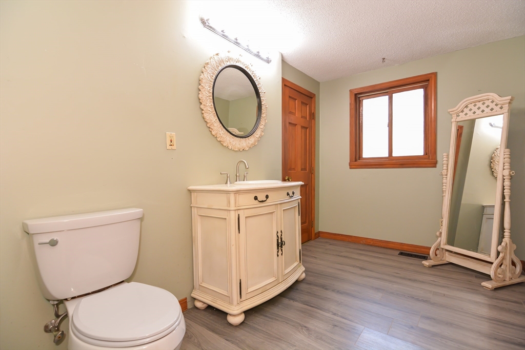 73 Drew Road Derry, NH 03038 - Photo 19 of 42 a white toilet sitting next to a bathroom sink
