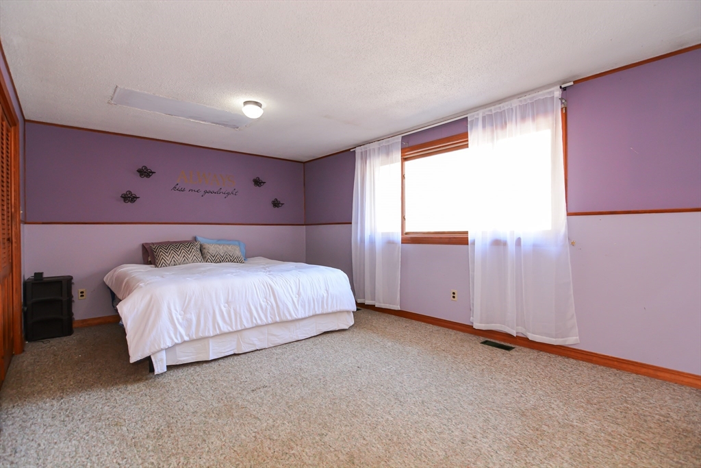 73 Drew Road Derry, NH 03038 - Photo 23 of 42 a bed room with a bed and a window