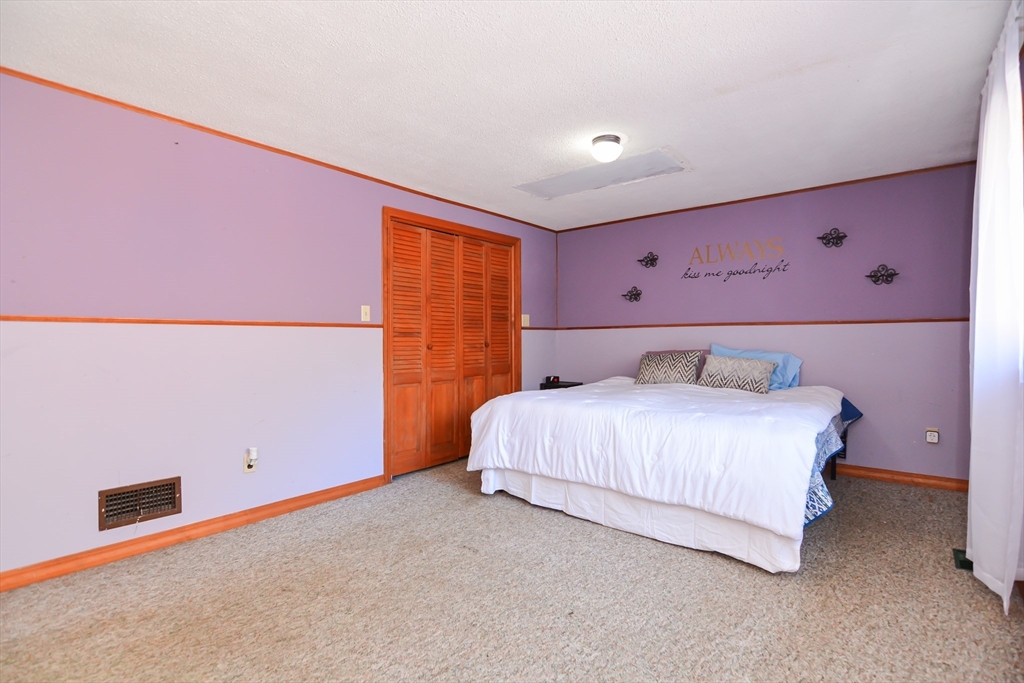 73 Drew Road Derry, NH 03038 - Photo 24 of 42 a bedroom with a bed and a window