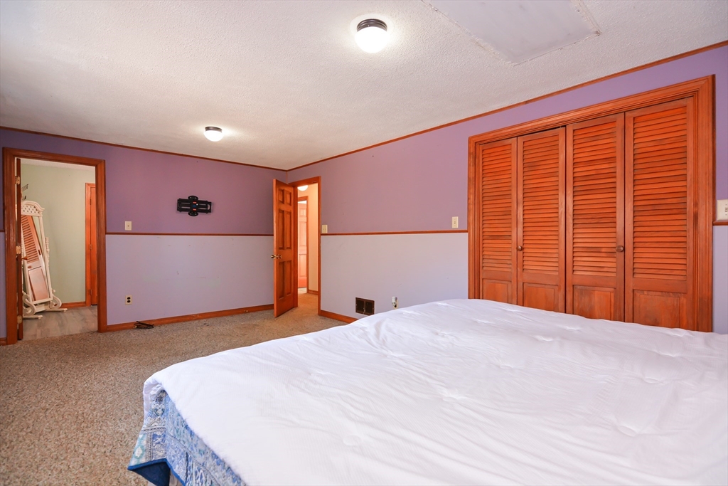 73 Drew Road Derry, NH 03038 - Photo 25 of 42 a bed room with a bed and a large window