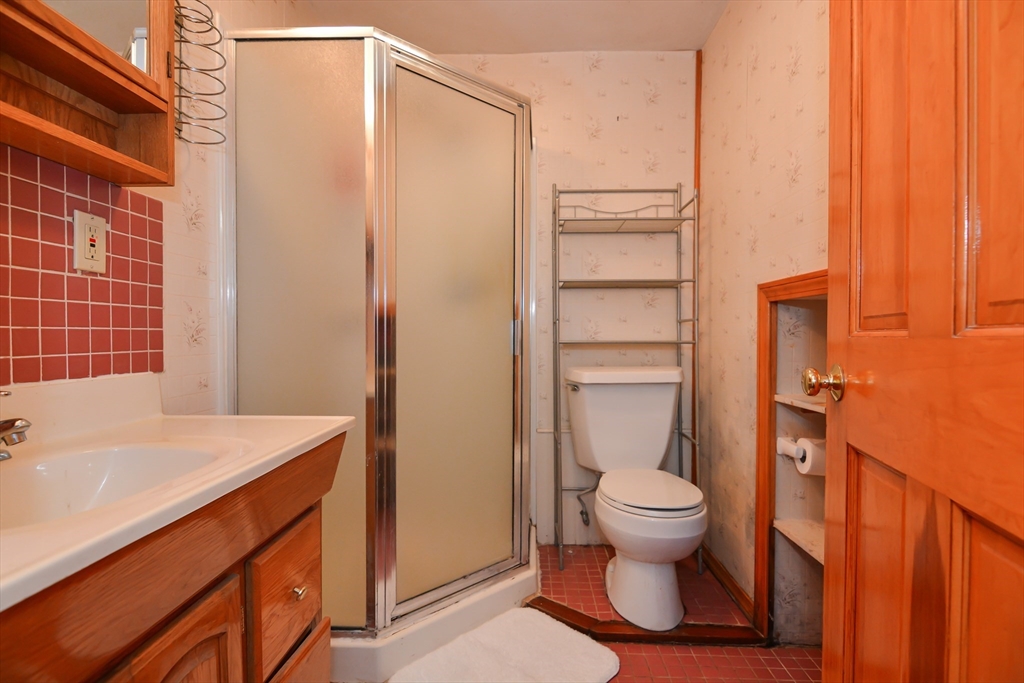 73 Drew Road Derry, NH 03038 - Photo 27 of 42 a bathroom with a granite countertop sink toilet and shower