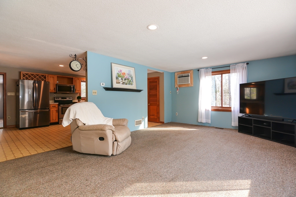 73 Drew Road Derry, NH 03038 - Photo 3 of 42 a living room with furniture and a flat screen tv