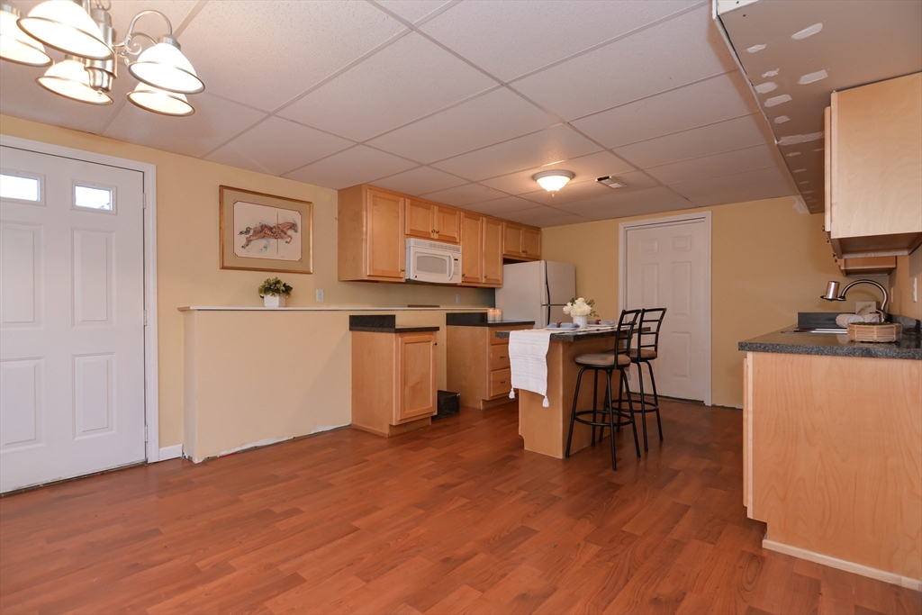 73 Drew Road Derry, NH 03038 - Photo 31 of 42 a view of kitchen with cabinets and wooden floor