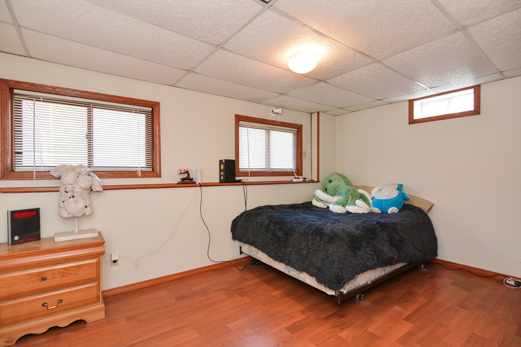 73 Drew Road Derry, NH 03038 - Photo 35 of 42 a bed sitting in a bedroom next to a window