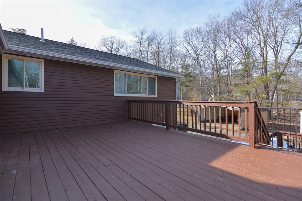 73 Drew Road Derry, NH 03038 - Photo 37 of 42 a view of backyard with deck and wooden floor