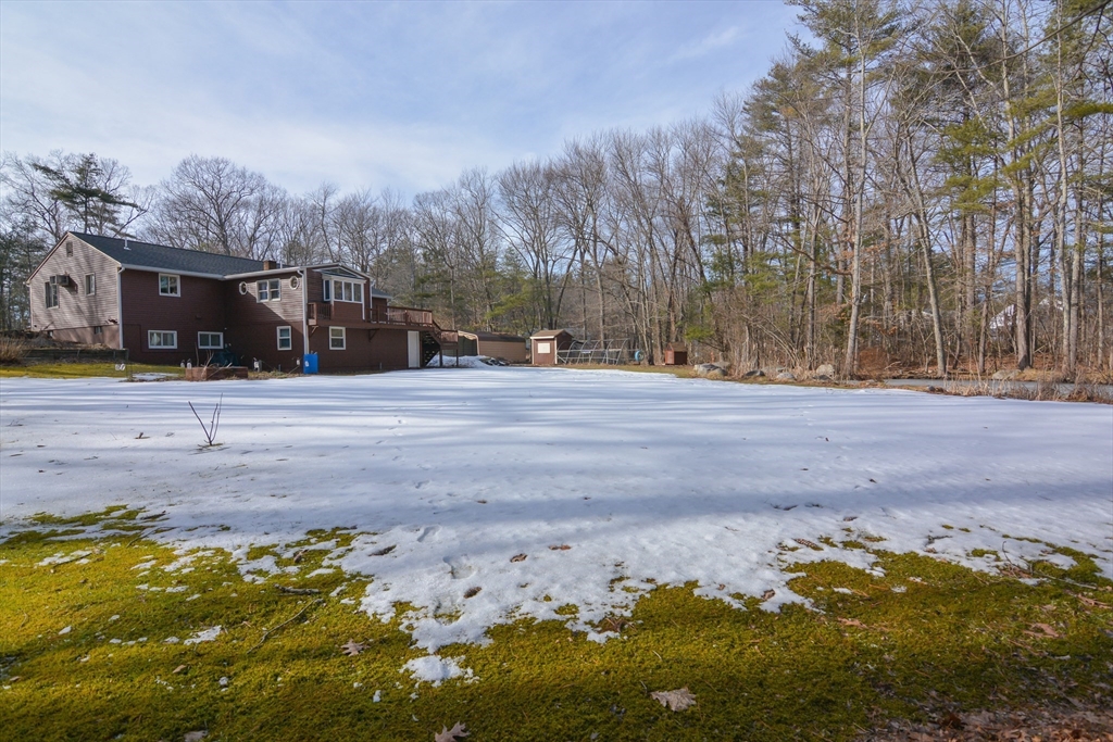 73 Drew Road Derry, NH 03038 - Photo 40 of 42 a backyard of a house with lots of green space and fog