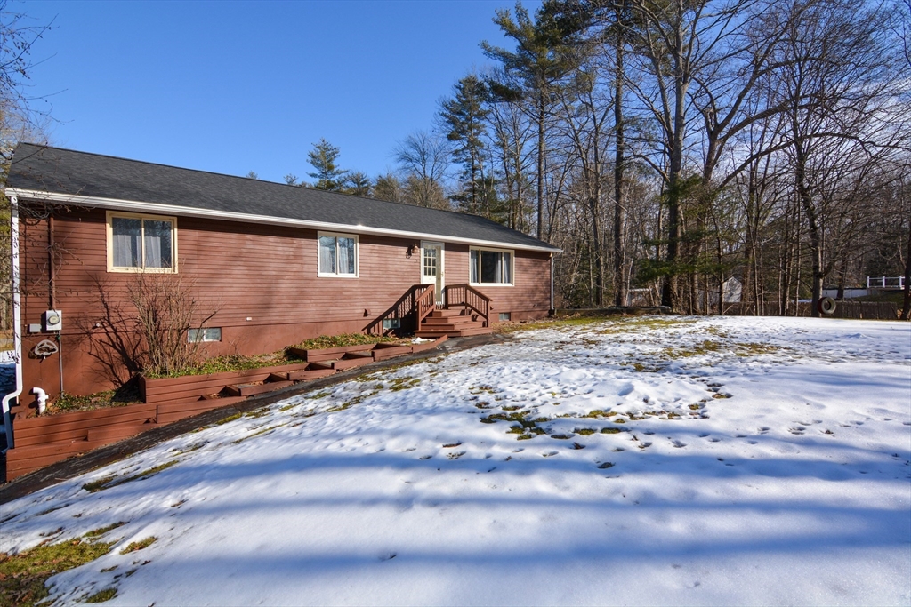 73 Drew Road Derry, NH 03038 - Photo 41 of 42 a view of a house with a yard covered in snow