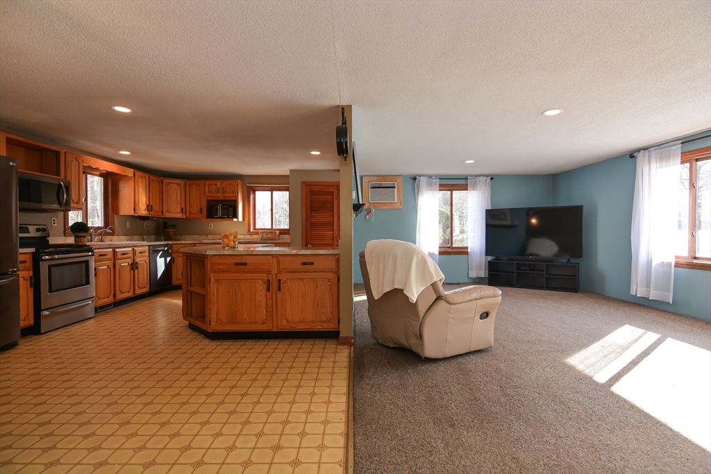 73 Drew Road Derry, NH 03038 - Photo 7 of 42 a living room with furniture and kitchen space