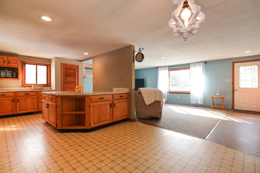 73 Drew Road Derry, NH 03038 - Photo 9 of 42 a large room with kitchen view and a window