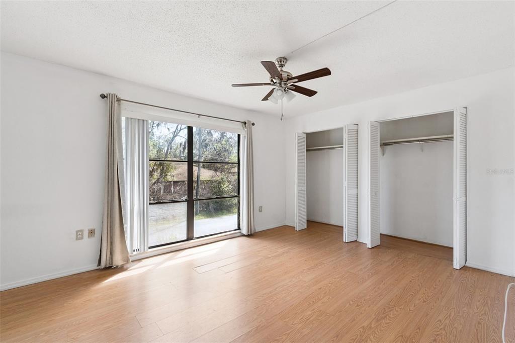 2811 Southwest Archer Road, Unit A2 Gainesville, FL 32608 - Photo 12 of 26 a view of empty room with wooden floor and fan