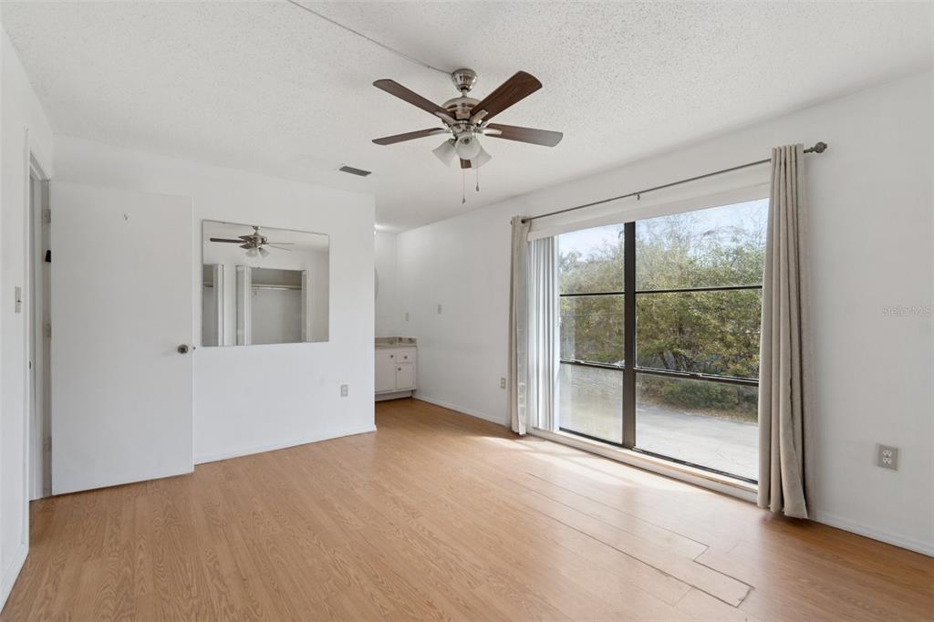 2811 Southwest Archer Road, Unit A2 Gainesville, FL 32608 - Photo 13 of 26 a view of a livingroom with a ceiling fan and window