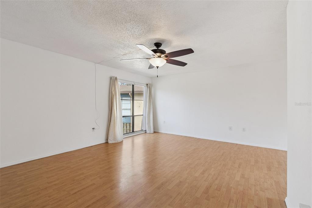 2811 Southwest Archer Road, Unit A2 Gainesville, FL 32608 - Photo 5 of 26 wooden floor in an empty room with a window
