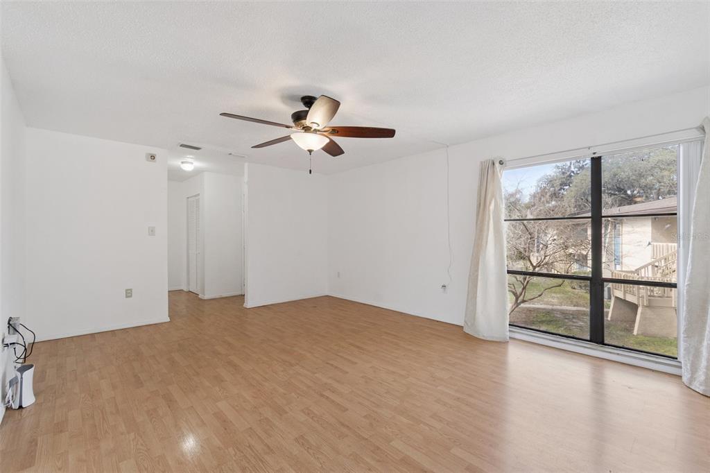2811 Southwest Archer Road, Unit A2 Gainesville, FL 32608 - Photo 6 of 26 wooden floor in an empty room with a window
