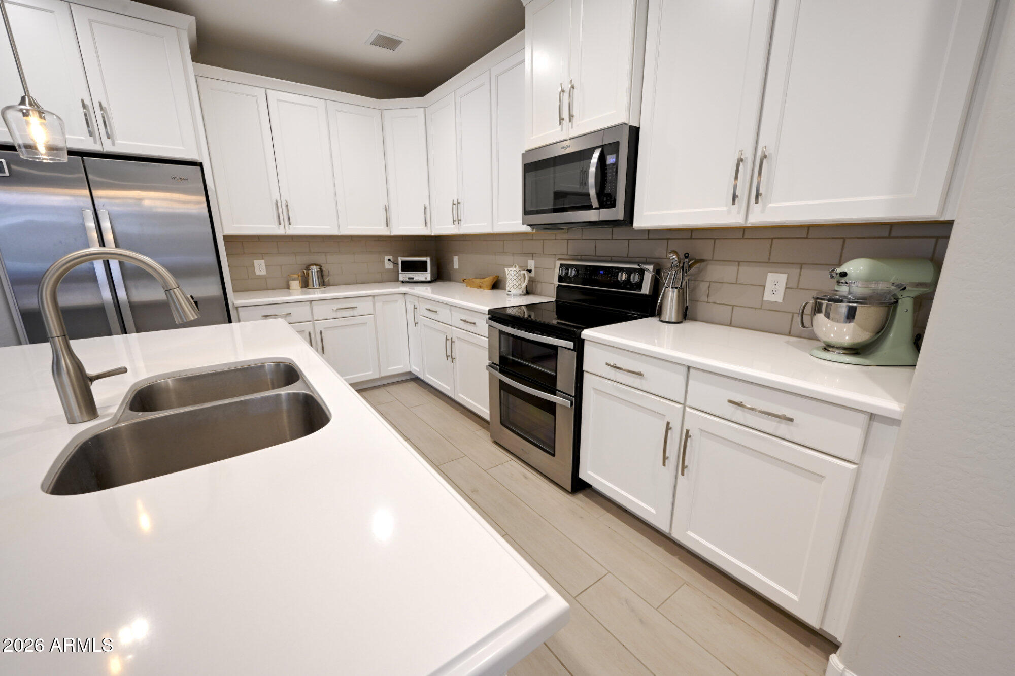 576 Whistle Stop Road Clarkdale, AZ 86324 - Photo 13 of 50 a kitchen with stainless steel appliances granite countertop a sink a stove top oven a counter space and cabinets