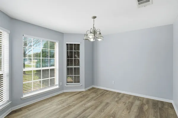 a view of wooden floor and windows in a room