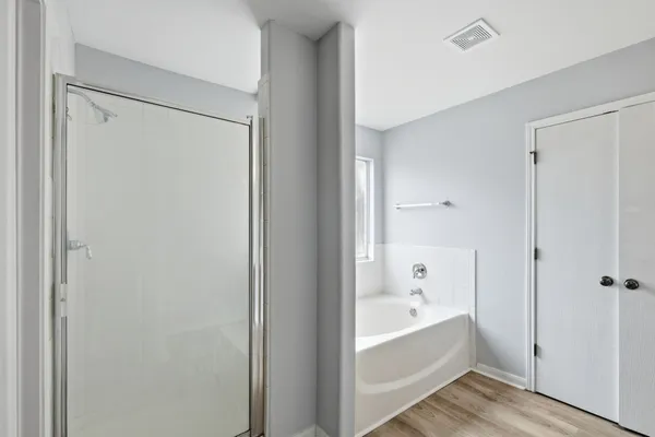 a bathroom with a bathtub and a shower
