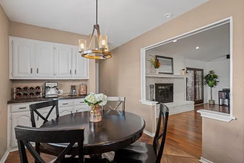 a view of a dining room with furniture wooden floor and chandelier