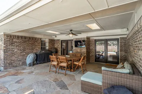 a dining room with furniture and a floor to ceiling window