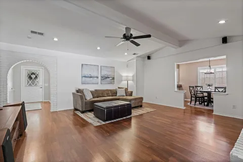 a living room with furniture and wooden floor