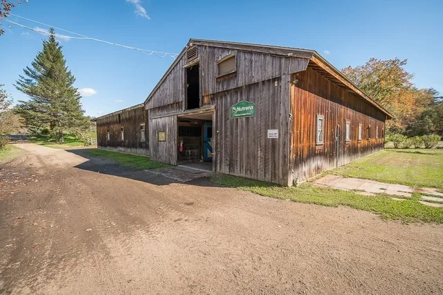 a view of a small house with a street