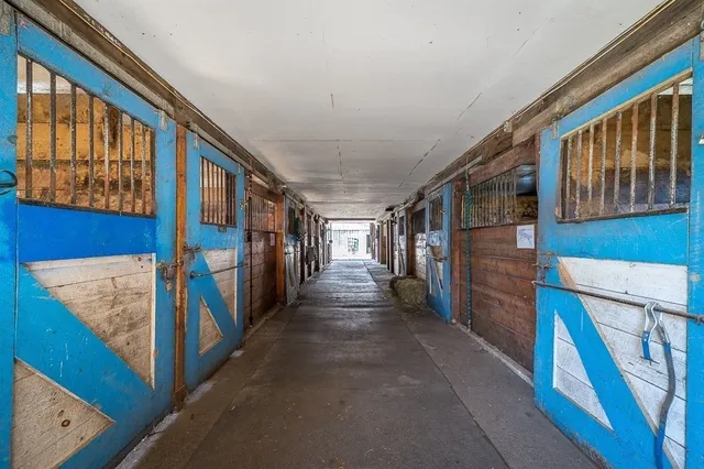 a view of a hallway with wooden stairs