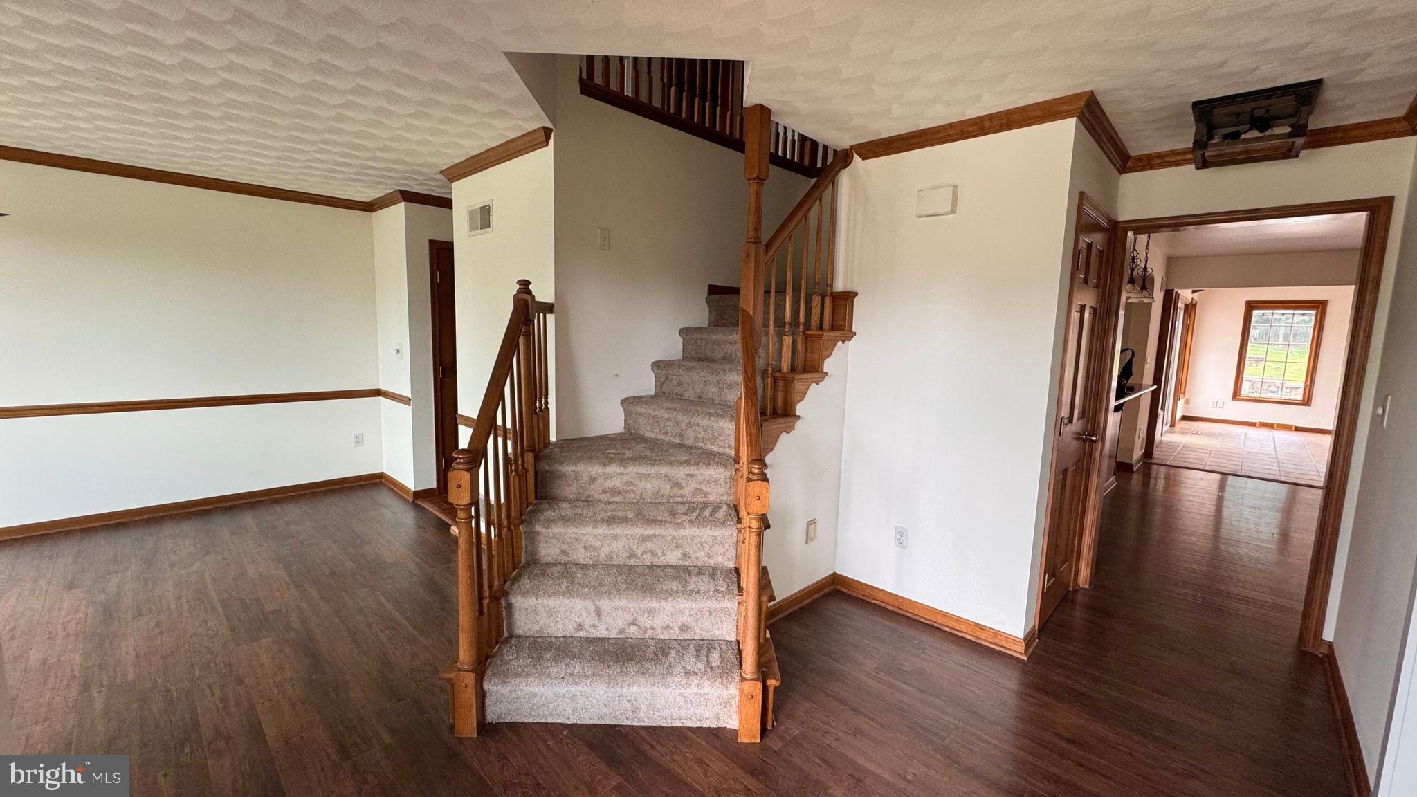 345 Jasmine Drive Hanover, PA 17331 - Photo 17 of 80 a view of a hallway with wooden floor and staircase