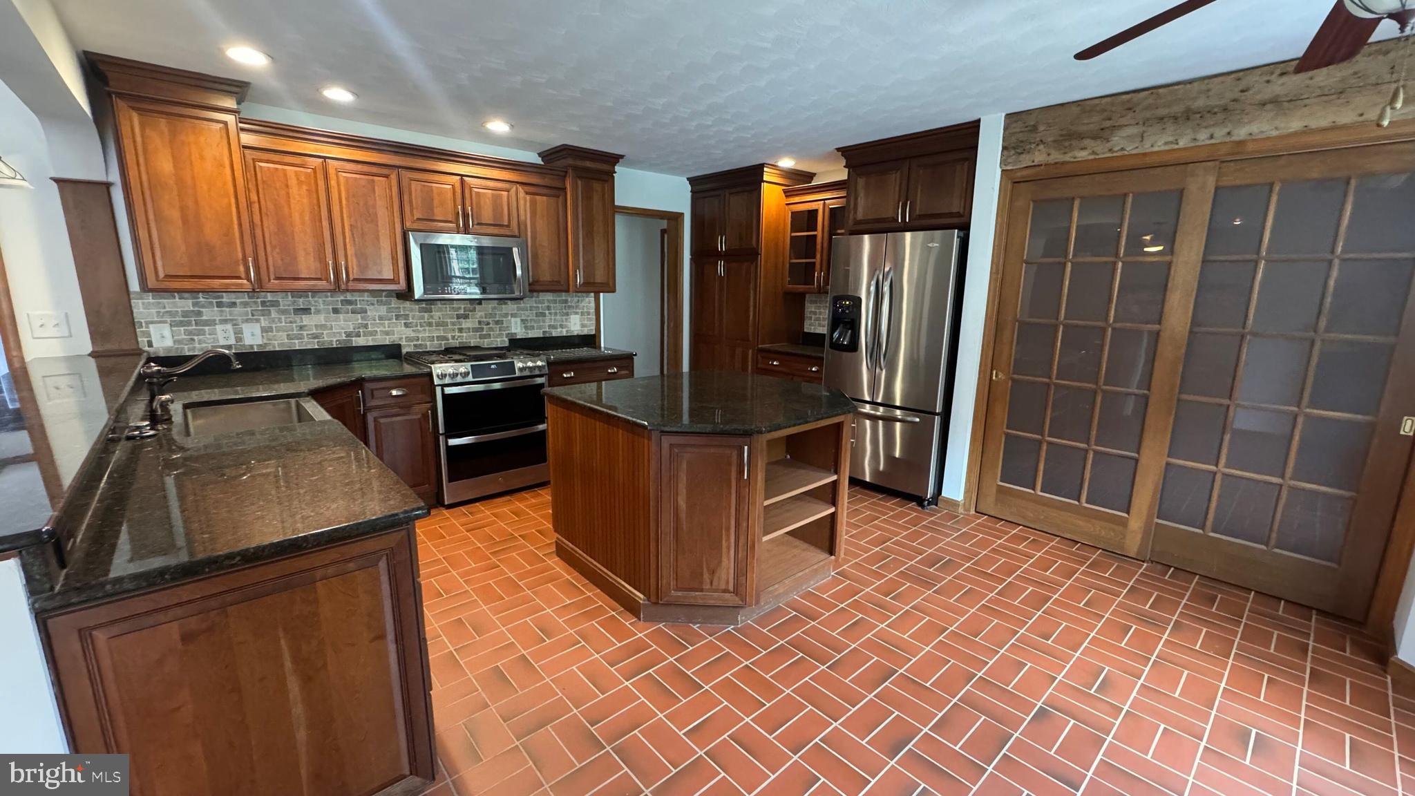 345 Jasmine Drive Hanover, PA 17331 - Photo 22 of 80 a kitchen with stainless steel appliances granite countertop a refrigerator and a sink