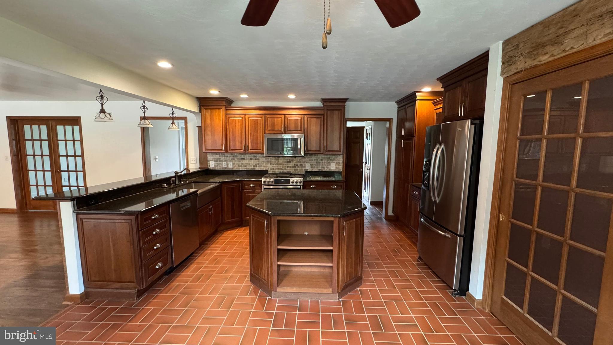 345 Jasmine Drive Hanover, PA 17331 - Photo 23 of 80 a kitchen with stainless steel appliances granite countertop a refrigerator a sink and wooden cabinets