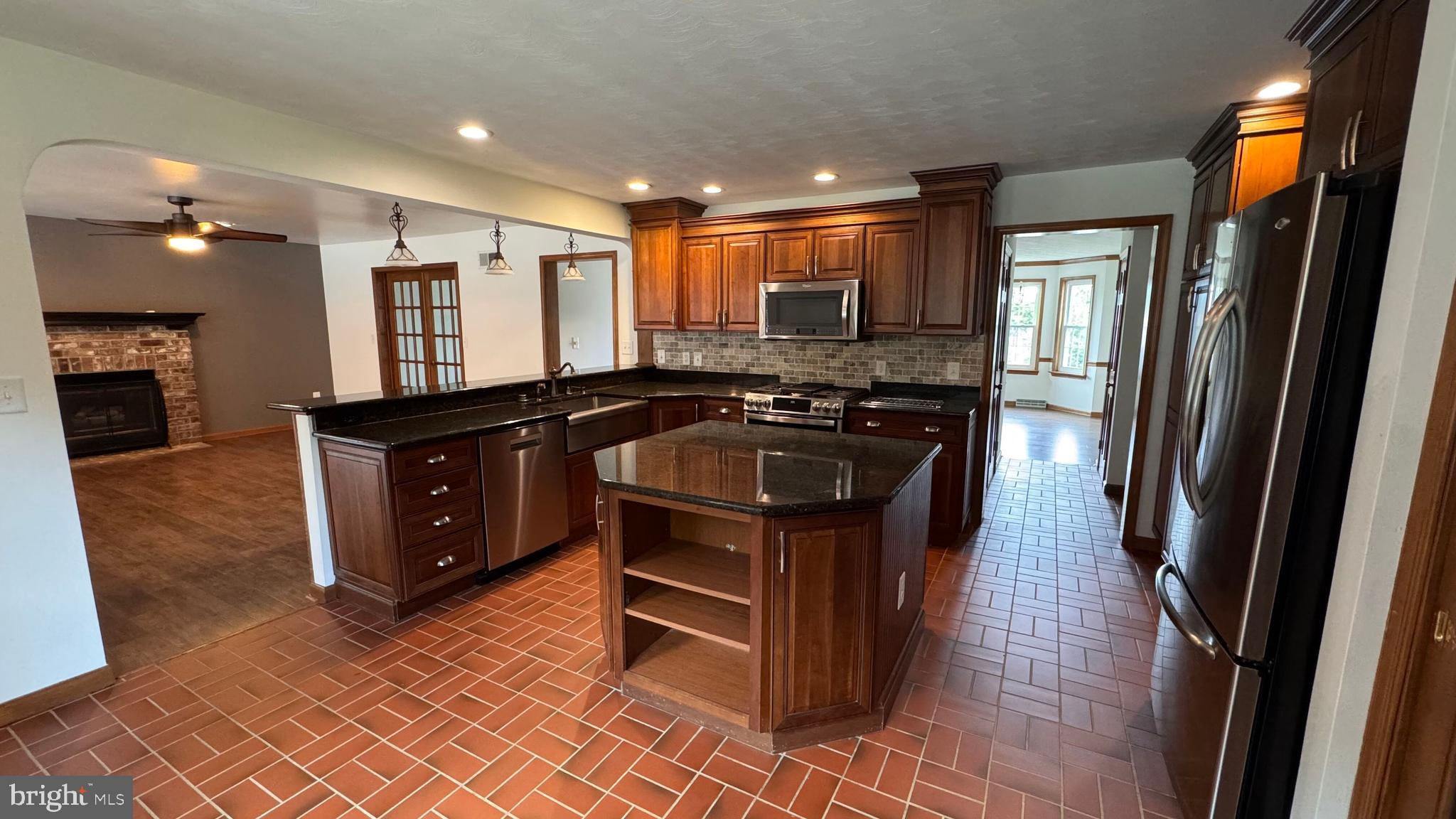 345 Jasmine Drive Hanover, PA 17331 - Photo 24 of 80 a kitchen with stainless steel appliances granite countertop a stove a sink and a refrigerator
