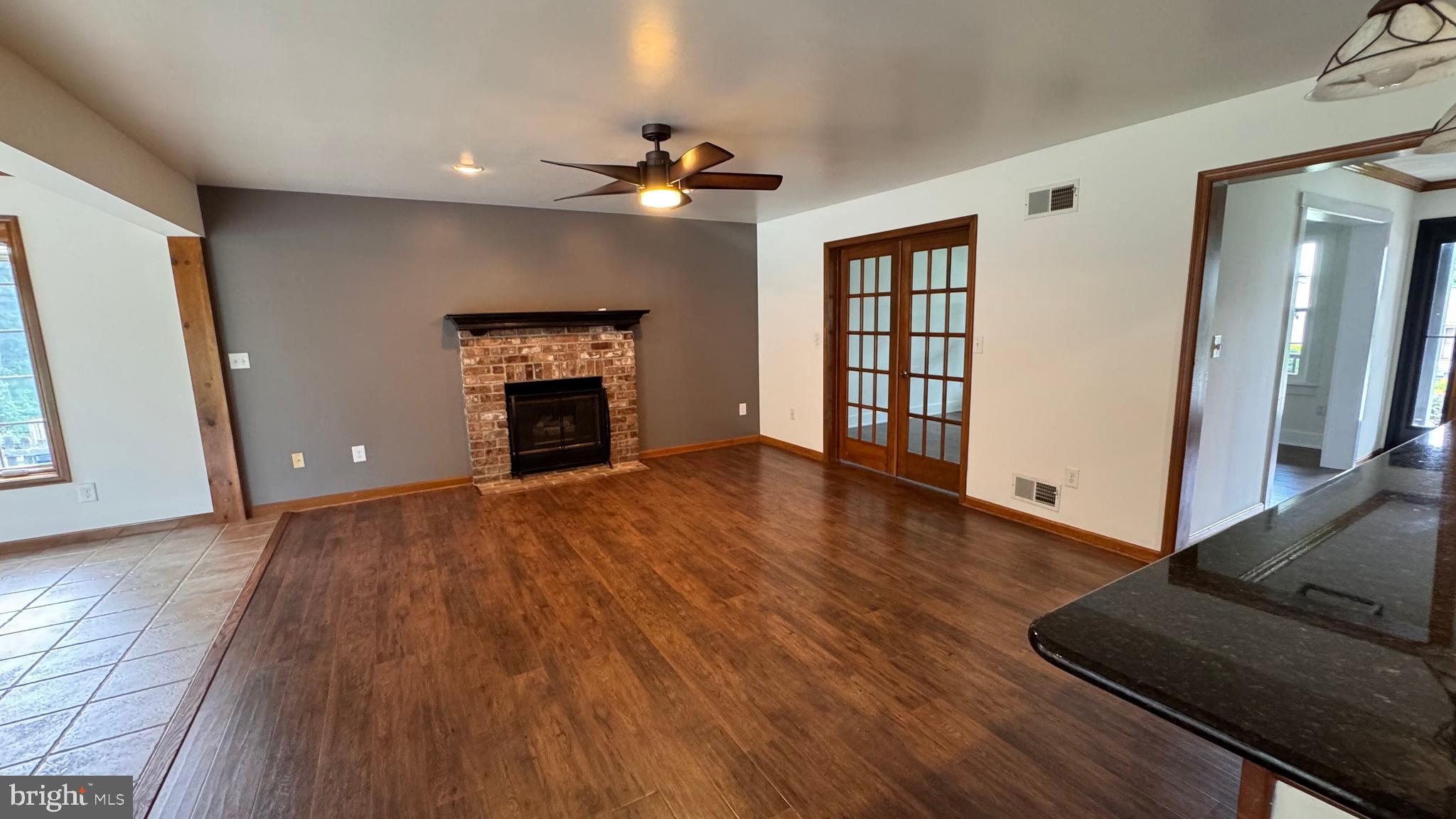 345 Jasmine Drive Hanover, PA 17331 - Photo 27 of 80 wooden floor fireplace and windows in an empty room