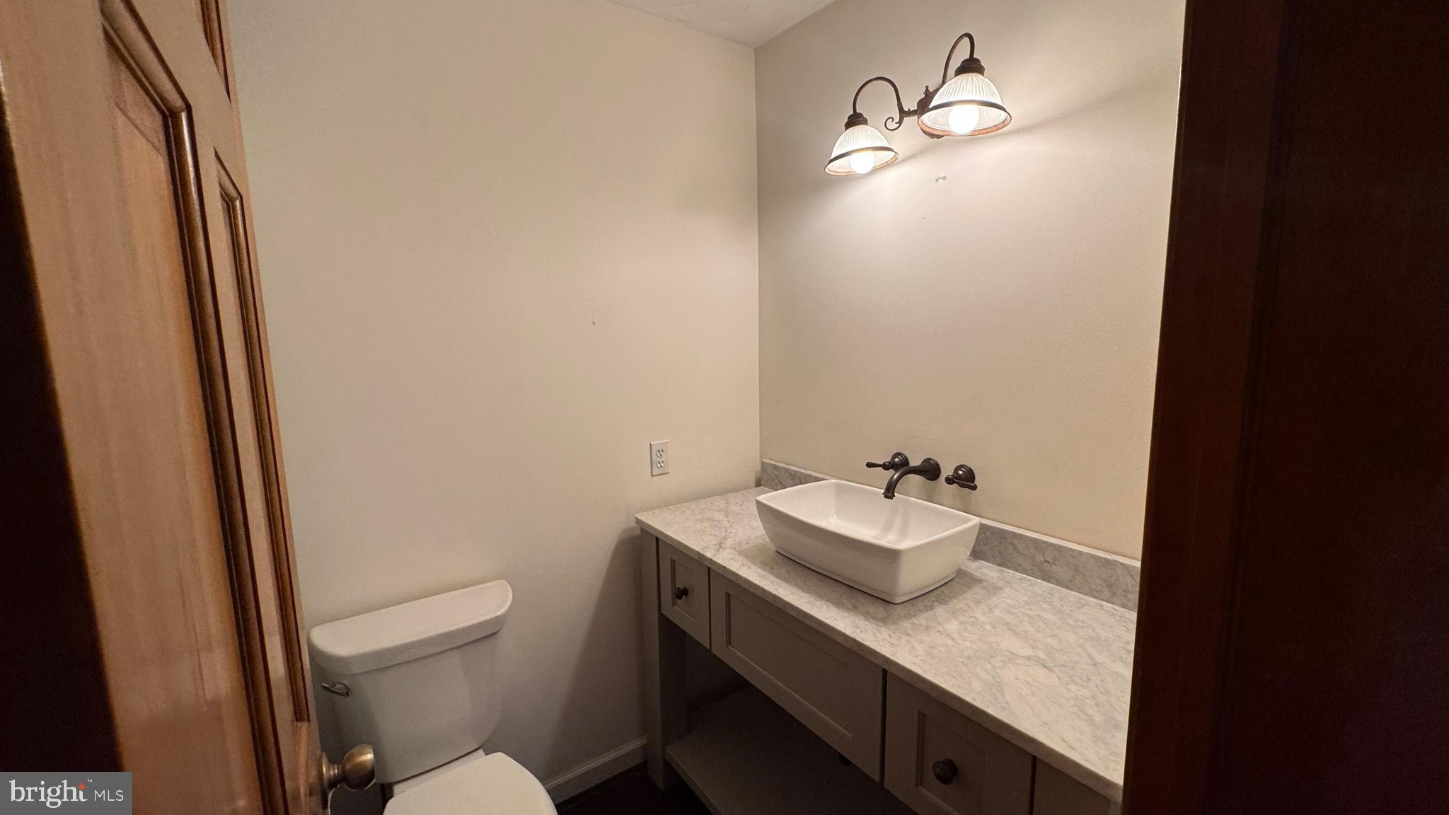 345 Jasmine Drive Hanover, PA 17331 - Photo 40 of 80 a bathroom with a granite countertop sink a toilet and a mirror
