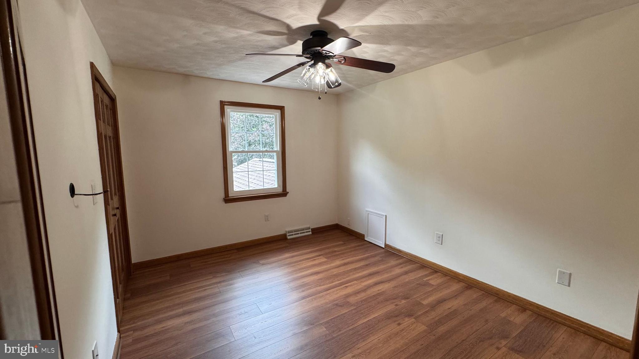 345 Jasmine Drive Hanover, PA 17331 - Photo 44 of 80 an empty room with wooden floor fan and windows