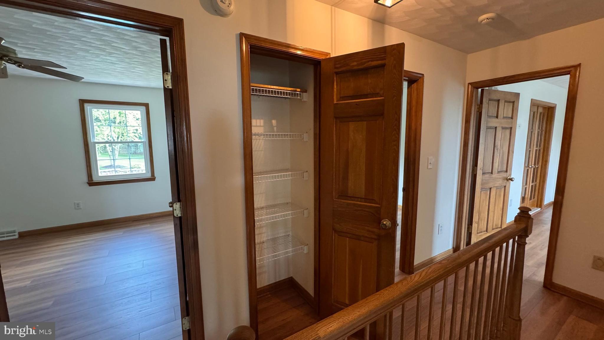 345 Jasmine Drive Hanover, PA 17331 - Photo 65 of 80 a view of a hallway with wooden floor and stairs