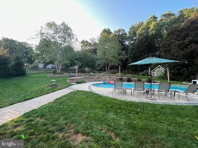 345 Jasmine Drive Hanover, PA 17331 - Photo 69 of 80 a view of a chair and table with umbrella in the garden
