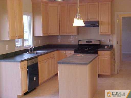 11 Miko Road Edison, NJ 08817 - Photo 3 of 8 a kitchen with stainless steel appliances a stove a sink and a microwave