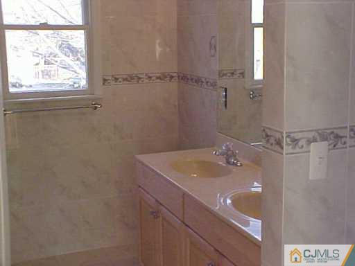 11 Miko Road Edison, NJ 08817 - Photo 5 of 8 a bathroom with a sink and a mirror