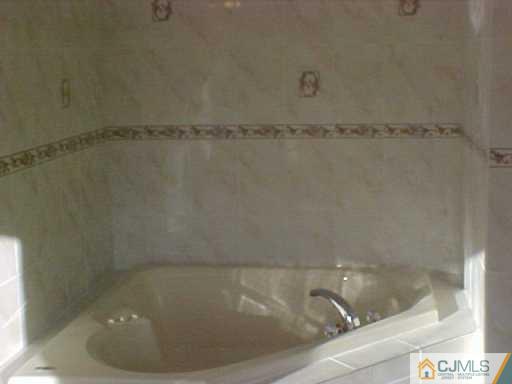 11 Miko Road Edison, NJ 08817 - Photo 7 of 8 a bath tub sitting next to a shower
