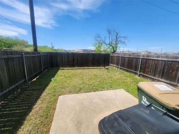 a view of a backyard with a wooden fence