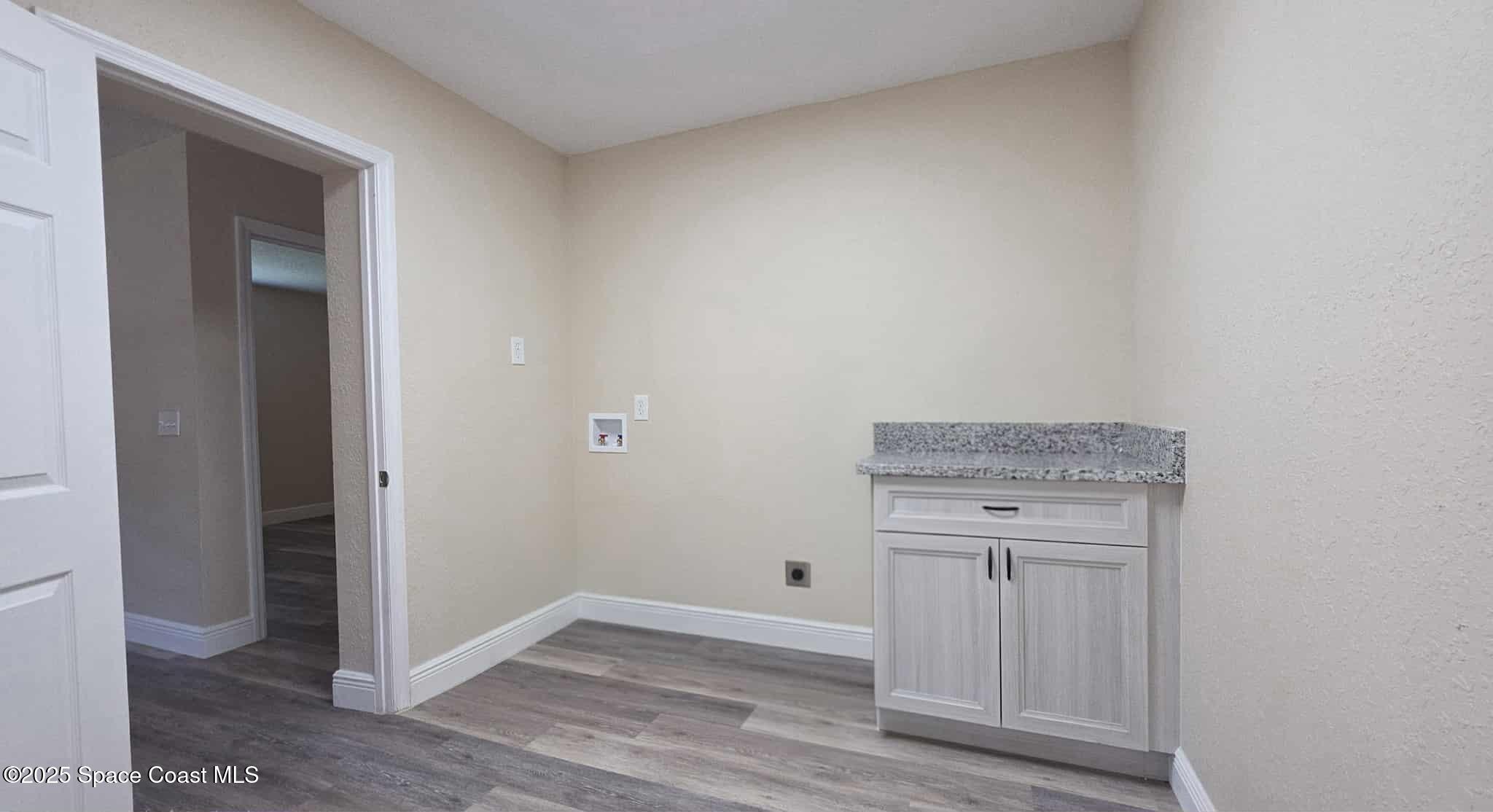 410 4th Street Merritt Island, FL 32953 - Photo 15 of 37 a view of cabinets and wooden floor
