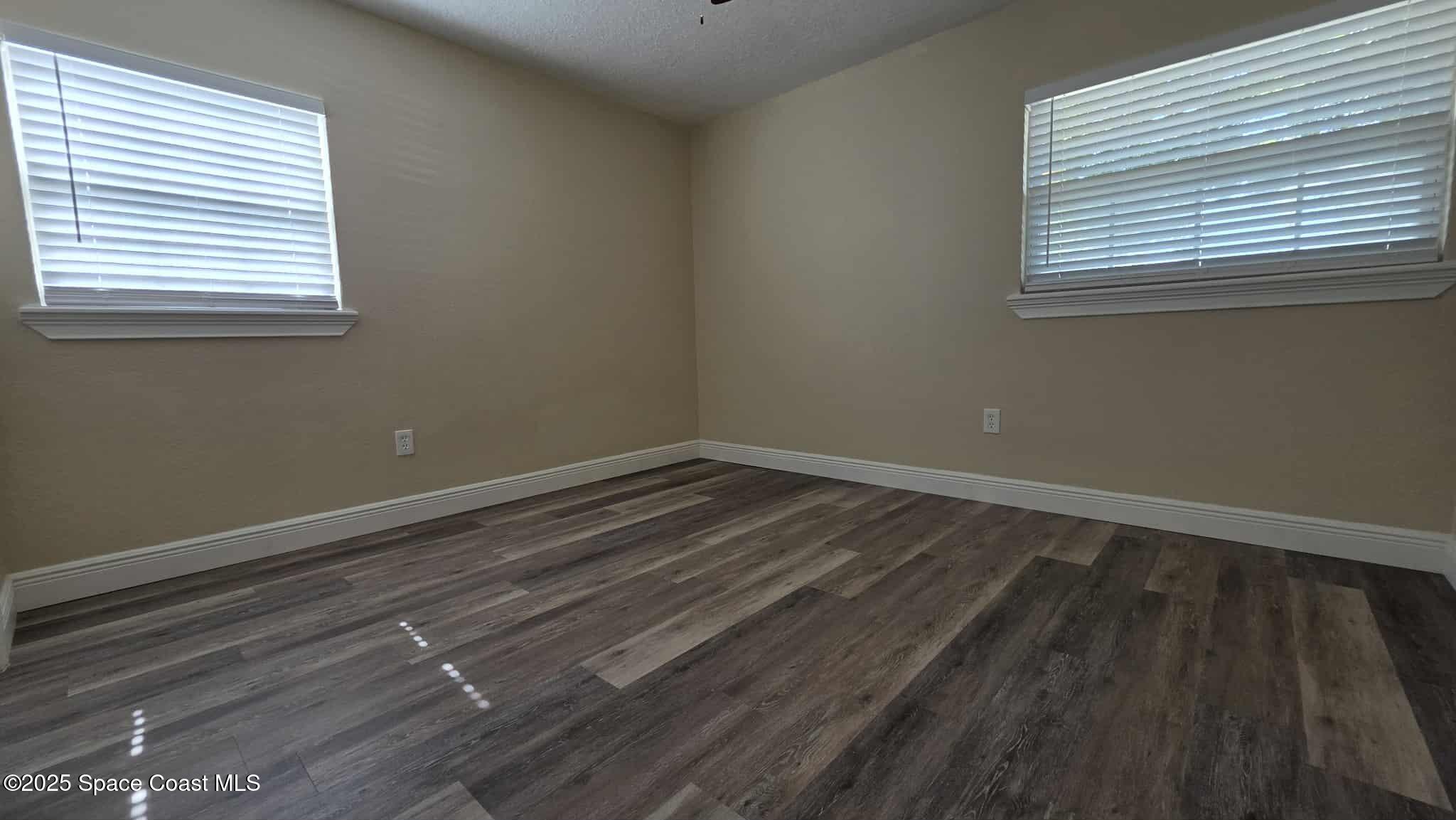 410 4th Street Merritt Island, FL 32953 - Photo 19 of 37 a view of a room that has wooden floor and a window