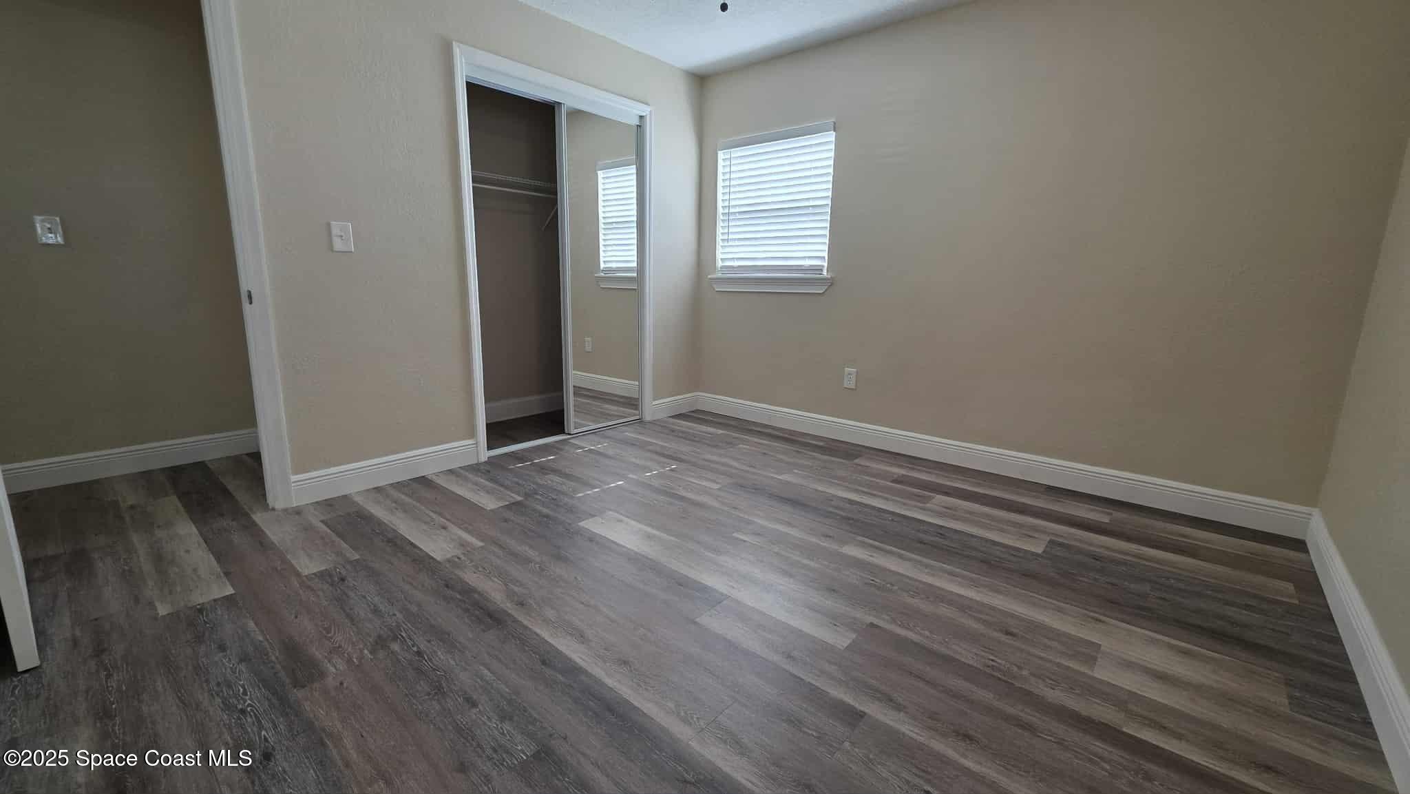 410 4th Street Merritt Island, FL 32953 - Photo 25 of 37 a view of an empty room with wooden floor and a window