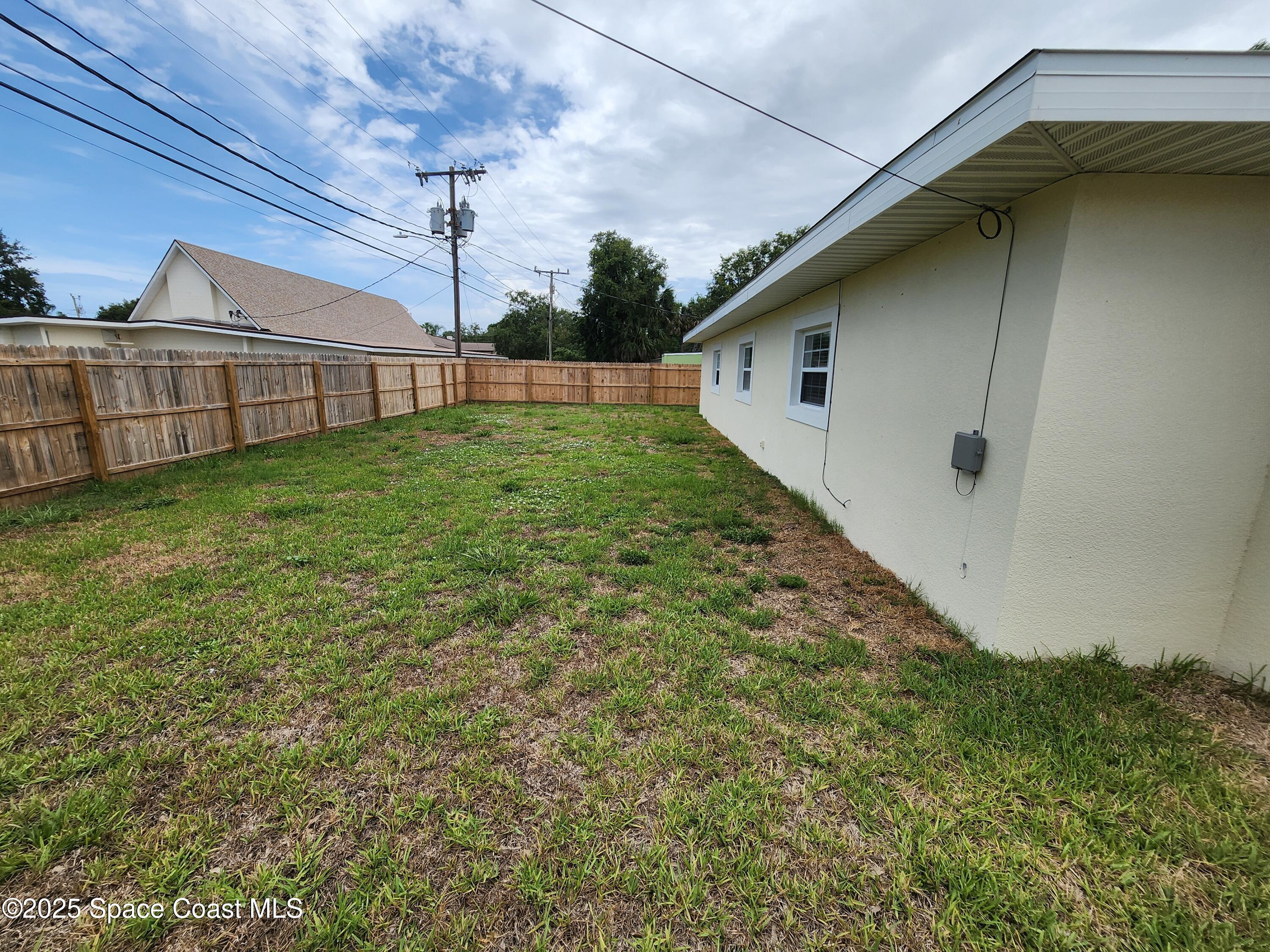 410 4th Street Merritt Island, FL 32953 - Photo 34 of 37 a backyard of a house with lots of green space