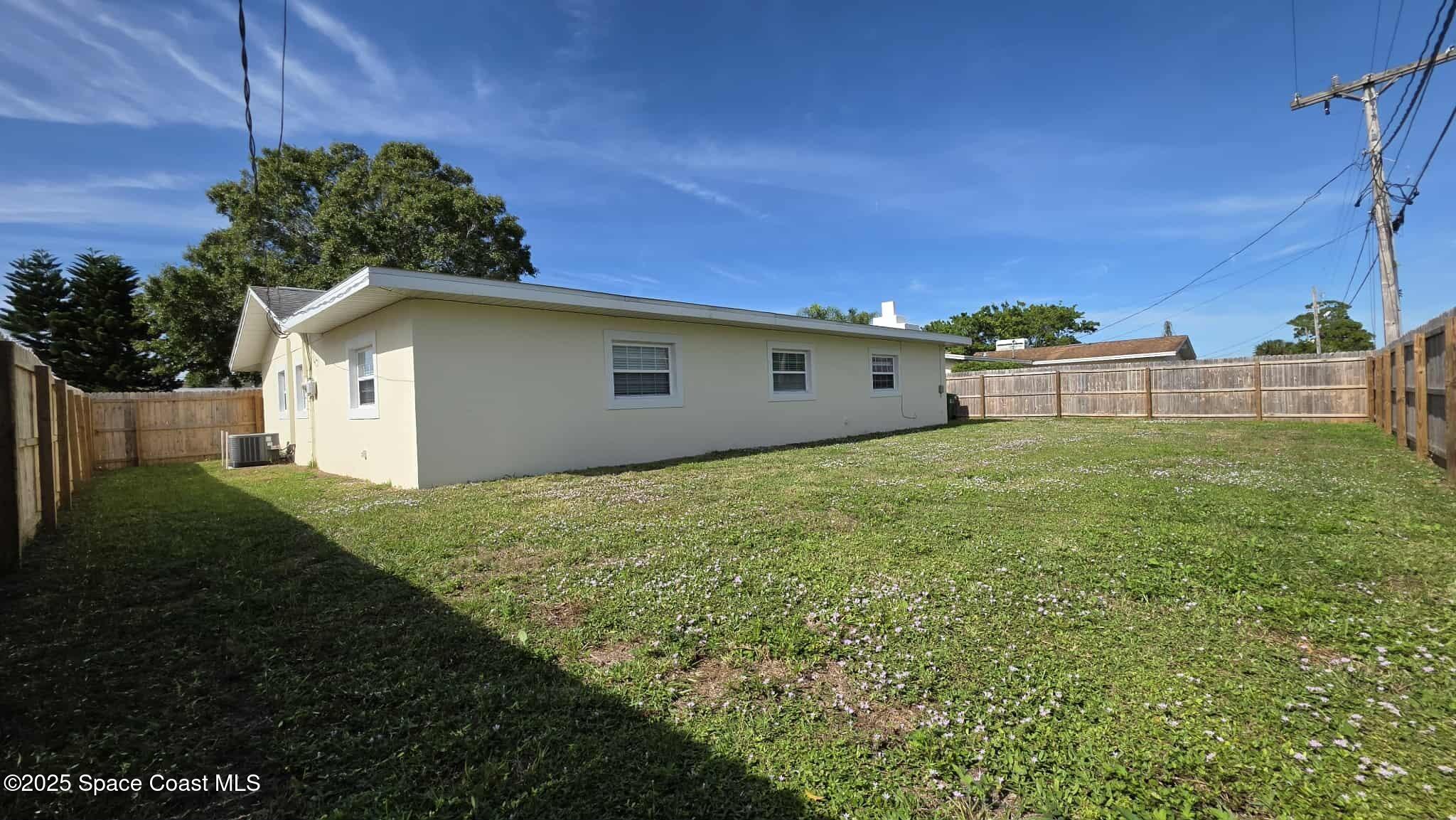 410 4th Street Merritt Island, FL 32953 - Photo 36 of 37 a view of a white house with a yard