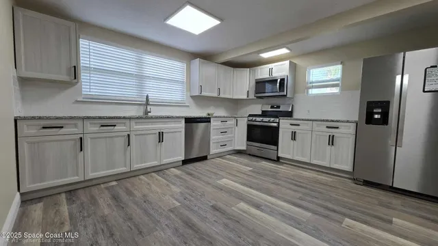 a view of a room with rack on the wall and a window