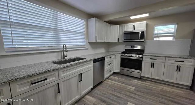 wooden floor in an empty room with a fireplace