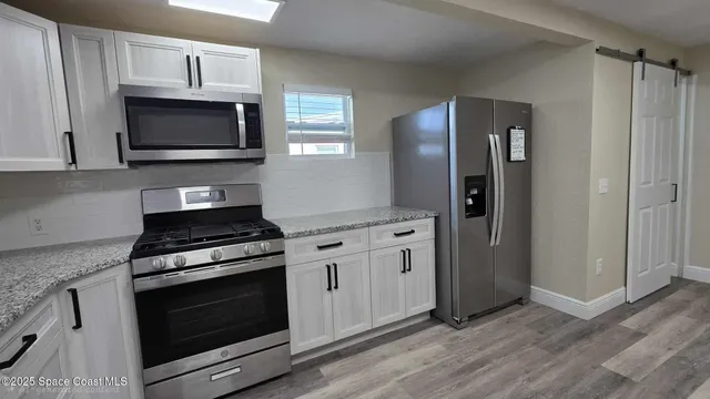 a view of cabinets and wooden floor