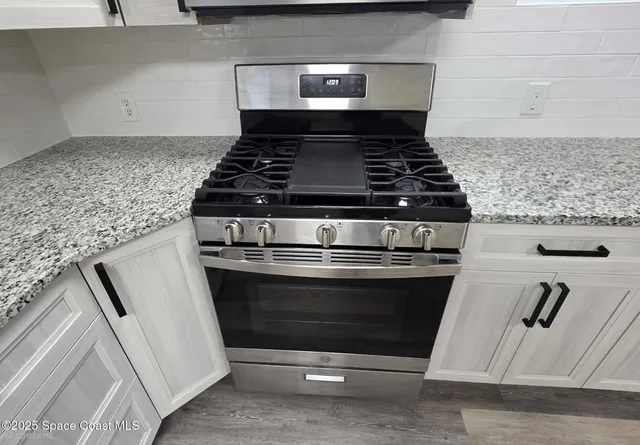 a view of room with window and hardwood floor