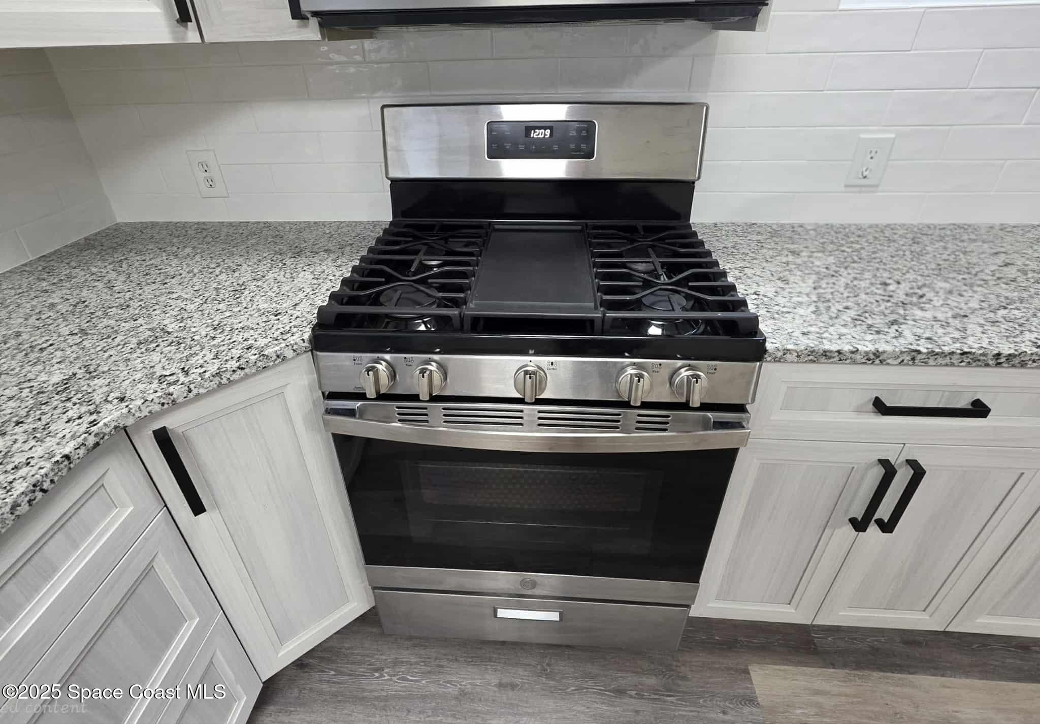 410 4th Street Merritt Island, FL 32953 - Photo 8 of 37 a stove top oven sitting inside of a kitchen